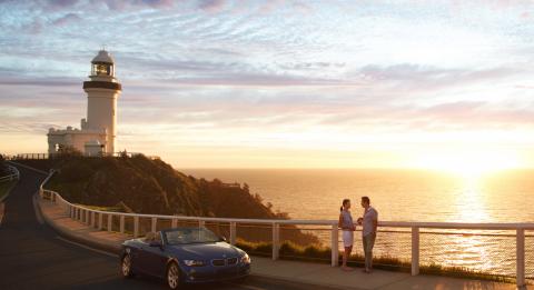 A couple enjoying sunrise at the Cape Byron Bay Lighthouse, Byron Bay
