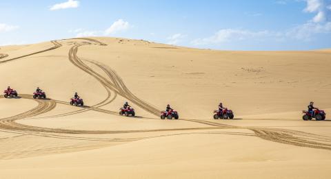 Small group enjoying an Aboriginal cultural tour on quad bikes with Sand Dune Adventures, Port Stephens