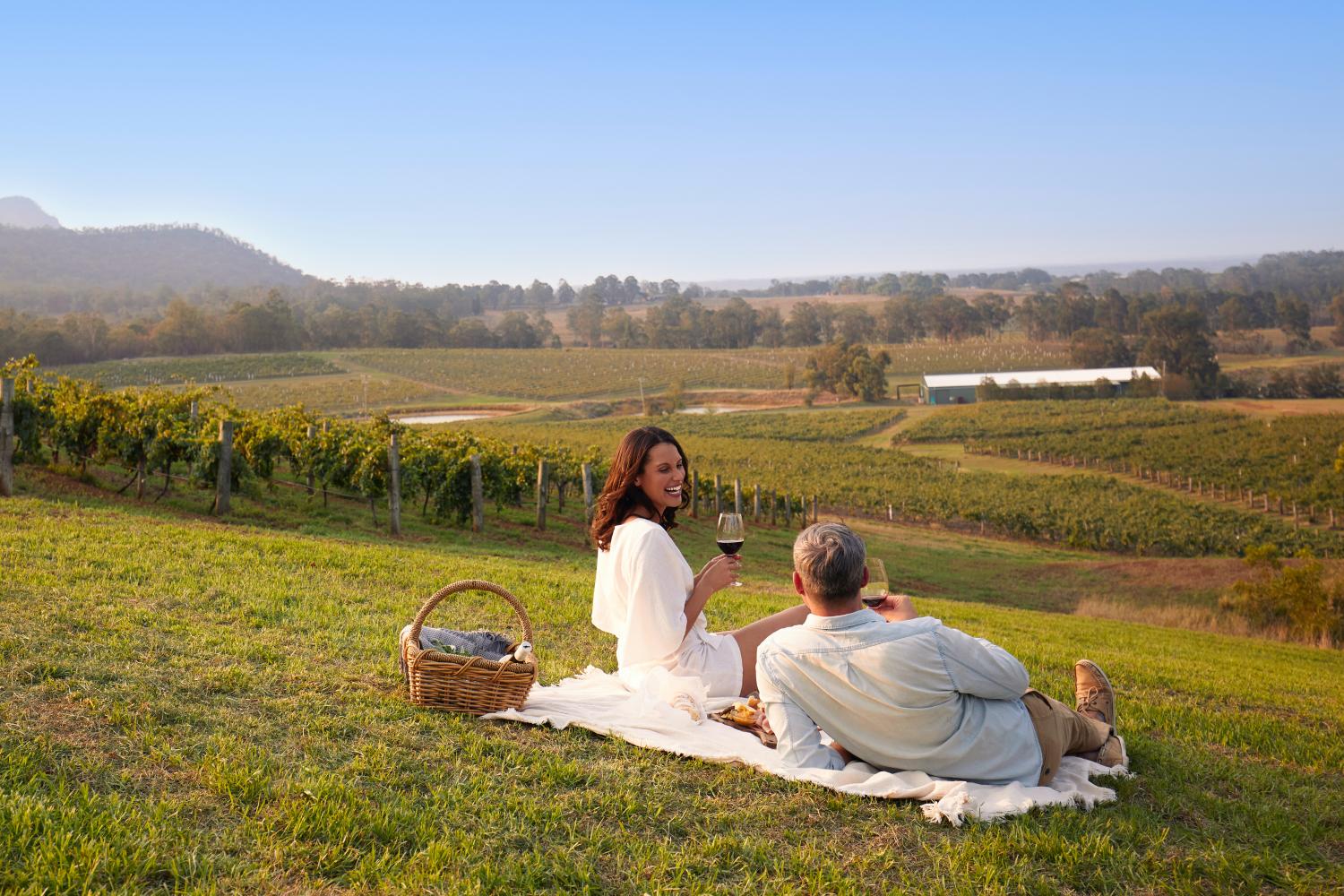 Couple enjoying a picnic at Audrey Wilkinson, Pokolbin in the Hunter Valley